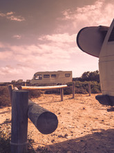 Camper Van With Surf Board On Beach