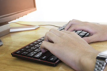 Close up of typing male hands on black keyboard,Businessman working concept,light effect