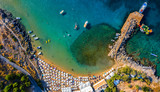 Fototapeta  - Aerial birds eye view photo taken by drone of iconic beaches in village of Lindos, Rhodes island, Dodecanese, Greece.
