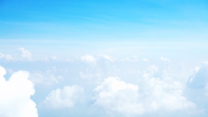 blue sky background with clouds, beautiful cloudscape, view over white fluffy clouds, freedom concept