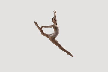 Wall Mural - Modern ballet dancer. Contemporary art ballet. Young flexible athletic woman.. Studio shot isolated on white background. Negative space.