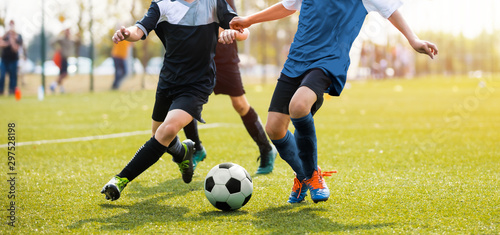 Cuadros en Lienzo Two soccer players running and kicking a soccer ball