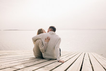 Couple Hugging On A Pier