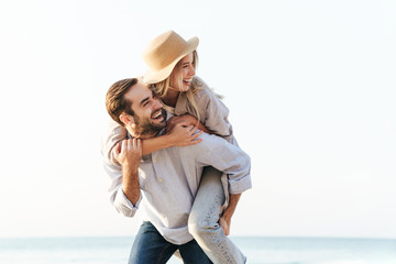 Wall Mural - beautiful happy young couple spending time at the beach