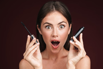 Canvas Print - Image of excited half-naked woman looking at camera and holding mascara