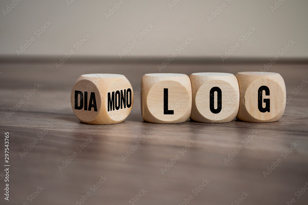 Cubes and dice on wooden background with the german words for dialogue and monologue - dialog und monolog - obrazy, fototapety, plakaty 