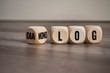 Cubes and dice on wooden background with the german words for dialogue and monologue - dialog und monolog