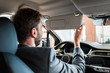 © LIGHTFIELD STUDIOS - selective focus of bearded man sitting in car and holding steering wheel