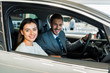 © LIGHTFIELD STUDIOS - selective focus of pretty woman sitting in car with man