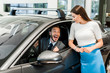 © LIGHTFIELD STUDIOS - attractive woman standing near excited man in car