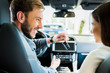 © LIGHTFIELD STUDIOS - selective focus of happy man and woman looking at each other in car