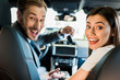 © LIGHTFIELD STUDIOS - selective focus of happy man and woman looking at camera in car