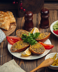 Canvas Print - fried minced meat in the bread with piece of tomato and lomen