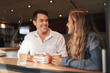 © StratfordProductions - Friends smiling and laughing in a cafe - having a great time together