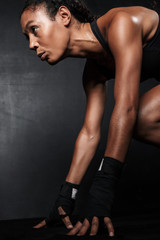 Image of athletic african american woman in sportswear doing workout