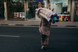 Man carrying carpet in Old Dubai