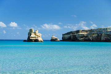 The Two Sisters stacks in front of the shore of Torre dell'Orso