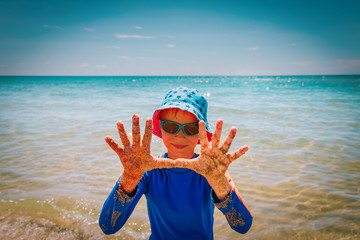 happy cute boy having fun on tropical beach