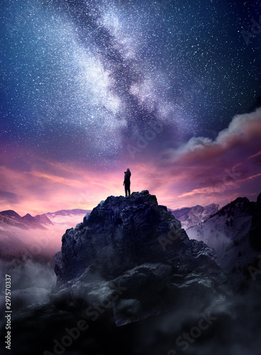 night-sky-long-exposure-landscape-a-man-standing-on-a-high-rock-watching-the-stars-rise-into-the-night-sky-photo-composite