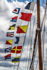 Nautical flags on the mast of a tall ship at Lunenburg, Nova Scotia