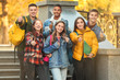 © Pixel-Shot - Group of teenage students showing thumb-up outdoors