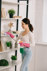 Wall Mural - happy housewife cleaning rack with rag and holding spray bottle with detergent