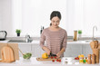 © LIGHTFIELD STUDIOS - attractive young woman cutting fresh vegetables on chopping board
