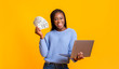 © Prostock-studio - African american young woman making money from internet, using laptop