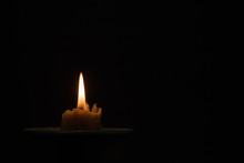 Burning Candle In A Black Ceramic Pot On A Dark Background. Concept Of Divination, Magic, Ritual. Copy Space.
