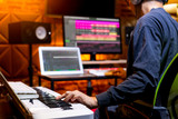 male producer, musician, composer making a song in home recording studio. music production concept