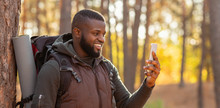 African Man Taking Photos Of Beautiful Autumn Forest