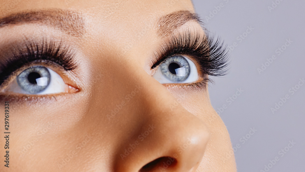 Woman eyes with long eyelashes and smokey eyes make-up. Eyelash extensions, makeup, cosmetics, beauty - obrazy, fototapety, plakaty 