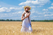 © Andrey_Arkusha - Young brunette woman in white dress walking in a wheat field