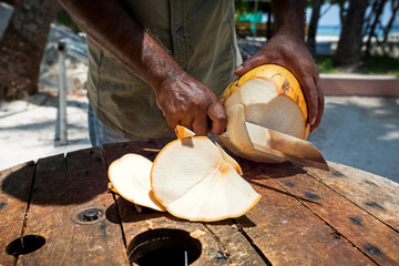 Opening with knife fresh green coconut