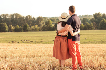 Wall Mural - married couple walking in the field