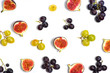 Figs and grapes on white background