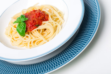 Wall Mural - Original Italian Spaghetti with fresh tomato sauce and fresh basil. White wood table background.