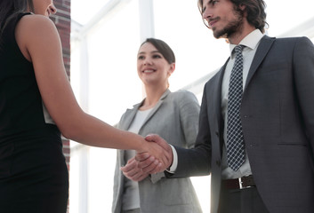 Wall Mural - Businesspeople shaking hands against room with large window loo