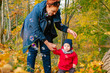 © sergei - autumn.a mother and her child walking in autumn Park and smiling