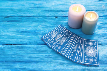 Wall Mural - Blue tarot cards deck on blue wooden table background.