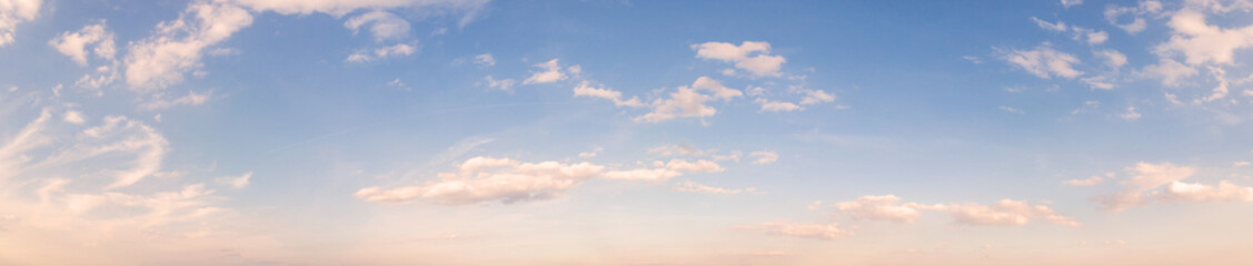 Summer sky background with warm sunny tonings. Wide angle panorama, banner