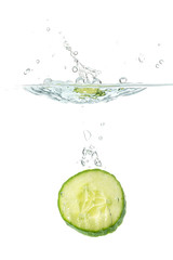 Wall Mural - Sliced cucumber splashing water isolated on white background. Skin moisturizing cosmetics