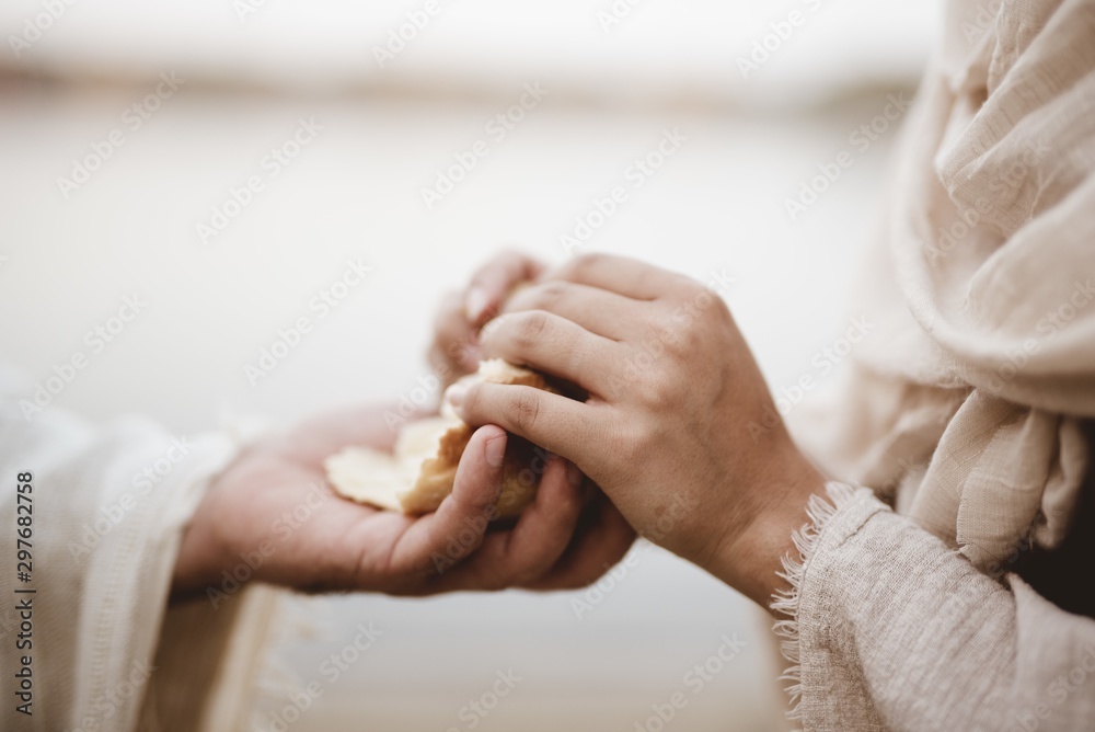 Biblical scene - of Jesus Christ handing out bread wit ha blurred background - obrazy, fototapety, plakaty 