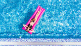 Fototapeta Przestrzenne - Beautiful young woman sunbathing on inflatable pink mattress at pool