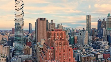 Wall Mural - Drone footage with slow rotation in front of New York City Lower Manhattan skyscrapers on a sunny afternoon before sunset