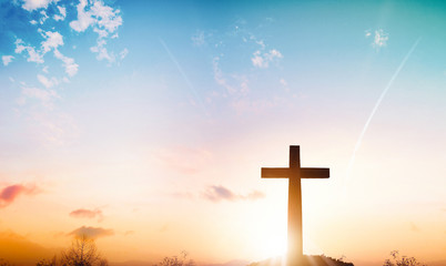 Wall Mural - christmas concept: the cross on mountain sunset background