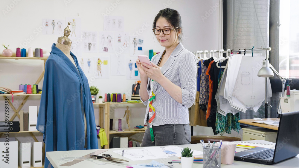 Happy fashion designer sending photo with new collection design on ...