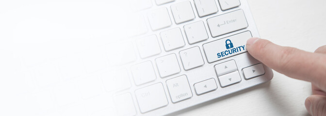 Finger pressing on computer keyboard. Security