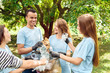 © Viktoriia - Volunteering. Young people volunteers outdoors together gathering various types of waste into bag talking smiling cheerful