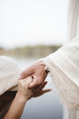 Vertical closeup shot of Jesus Christ healing a female with a blurred background